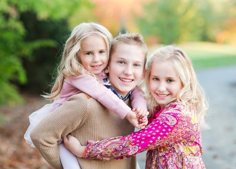 three blonde siblings in outdoor fall portrait in ruxton