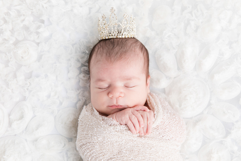 newborn baby girl with a crown portrait